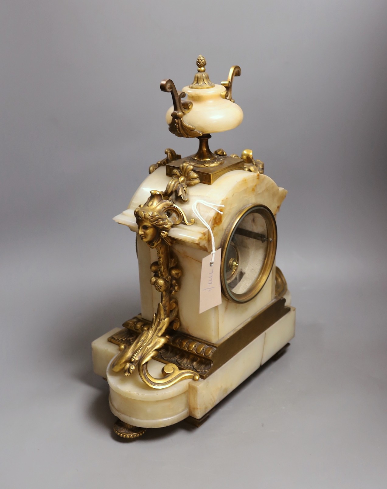 A late 19th century French ormolu mounted alabaster mantel clock. 42cm tall